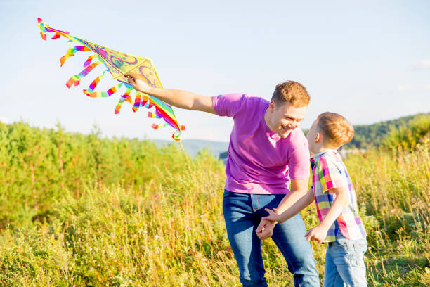 istock Father and son playing with a kite 855069618