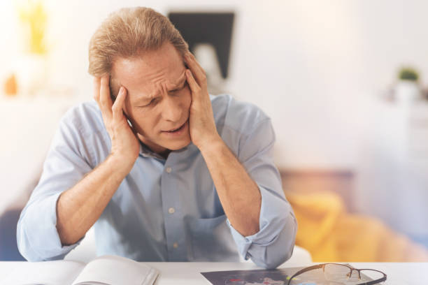 istock Tired mature man sitting in the office 855070116