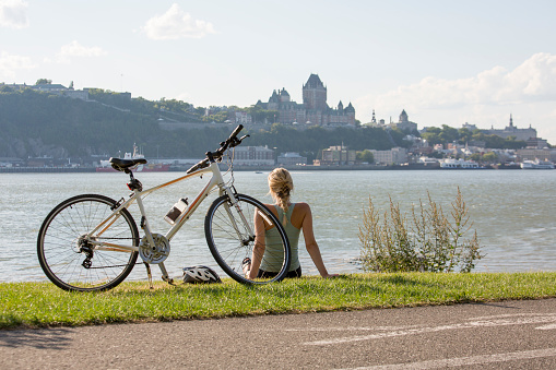 A Young Woman with Bike outside with quebec view