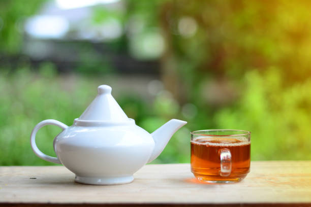 istock a tea pot and a cup of tea  on wooden table 855093880