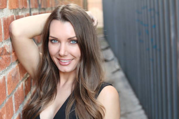 istock Gorgeous woman smiling on urban background 855094486