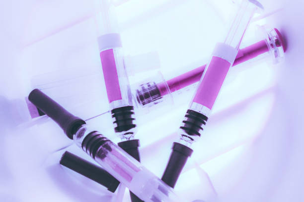 Syringes inside a Sharps Collector stock photo