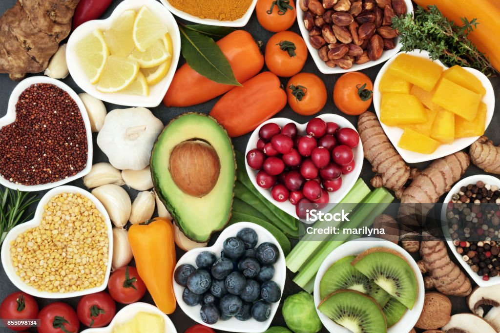 Health Food for Fitness Health food for fitness concept with fresh fruit, vegetables, pulses, herbs, spices, nuts, grains and pulses. High in anthocyanins, antioxidants,smart carbohydrates, omega 3 fatty acids,  minerals and vitamins. Healthy Lifestyle Stock Photo