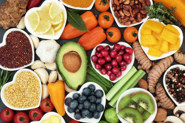 Health Food for Fitness Health food for fitness concept with fresh fruit, vegetables, pulses, herbs, spices, nuts, grains and pulses. High in anthocyanins, antioxidants,smart carbohydrates, omega 3 fatty acids,  minerals and vitamins. fibre stock pictures, royalty-free photos & images