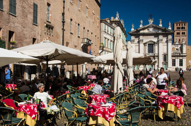 Tourists await service in a cafe on the Piazza Sordello in Mantova, Italy. stock photo