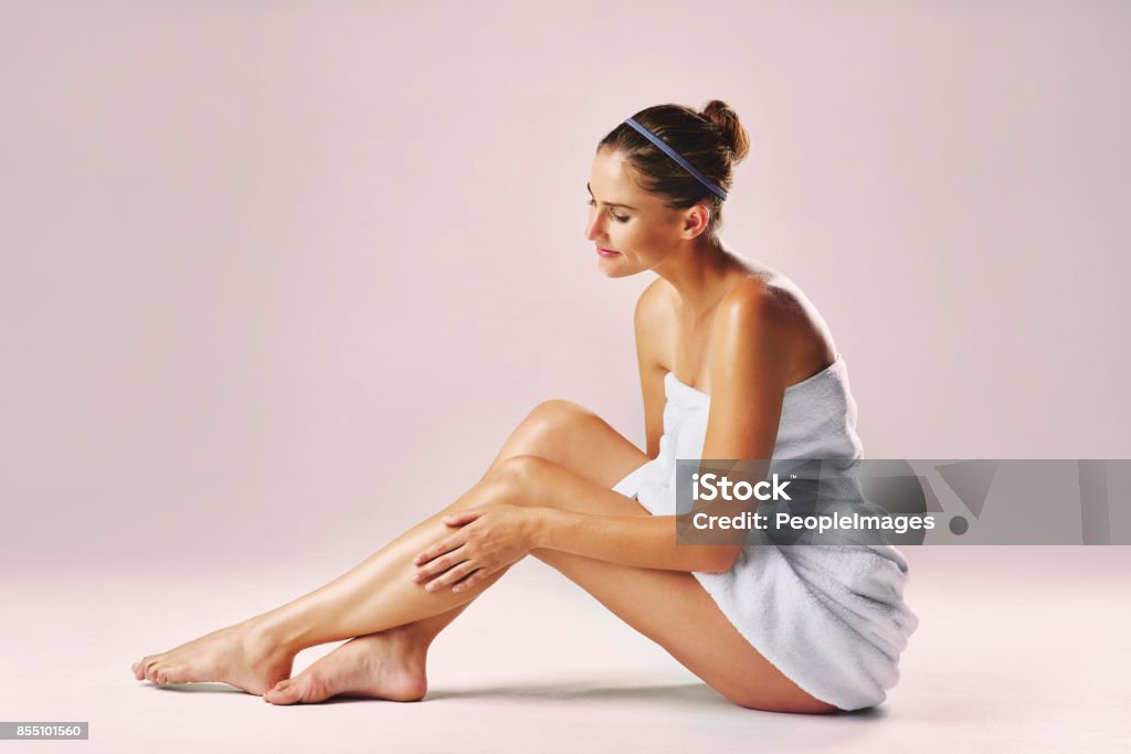 Every woman's dreams, smooth and soft legs Studio shot of an attractive woman showing off her beautiful legs against a pink background Women Stock Photo