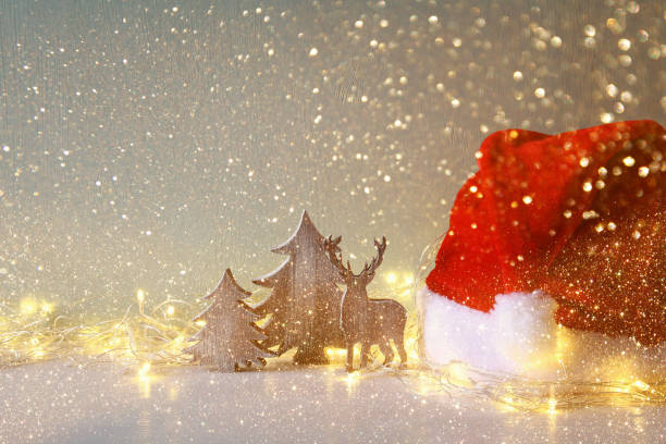 istock wooden christmas tree and deer with garland lights 855106004