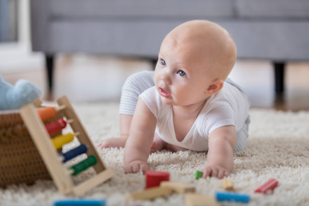istock Curious baby crawls on the floor 855109806