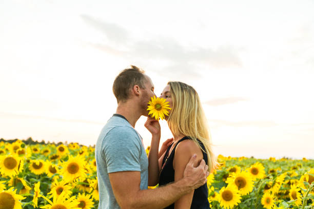 A Beautiful couple having fun in sunflowers fields