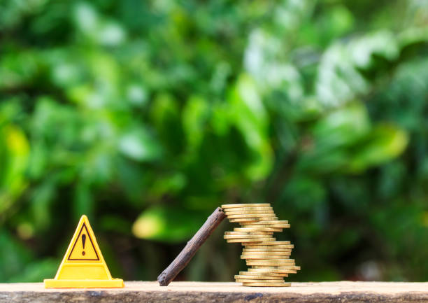 istock stop sign and Coins are risky on smart phone or cellphone on nature. 855120430