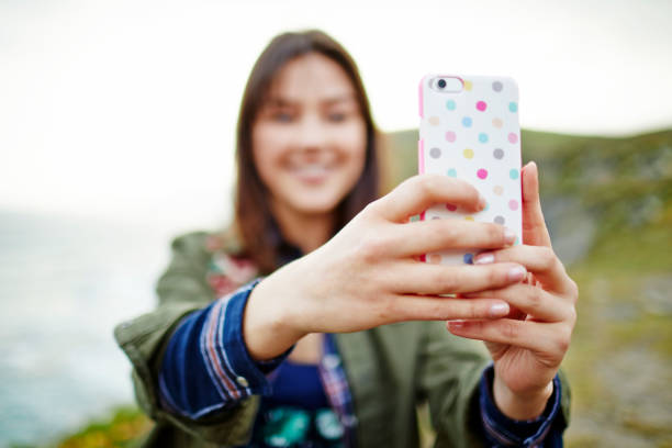istock Woman taking selfie with smart phone on mountain 855120964