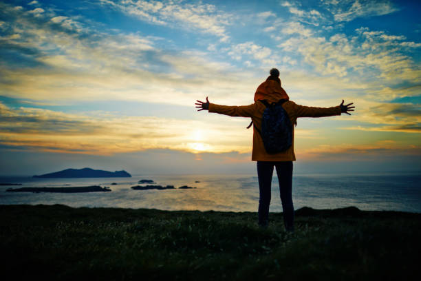 istock Hiker standing with arms outstretched on mountain during sunset 855123864