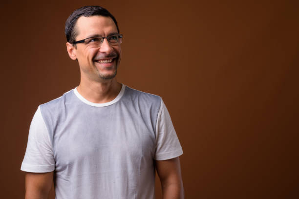 istock Studio shot of handsome man wearing eyeglasses against colored background 855124526