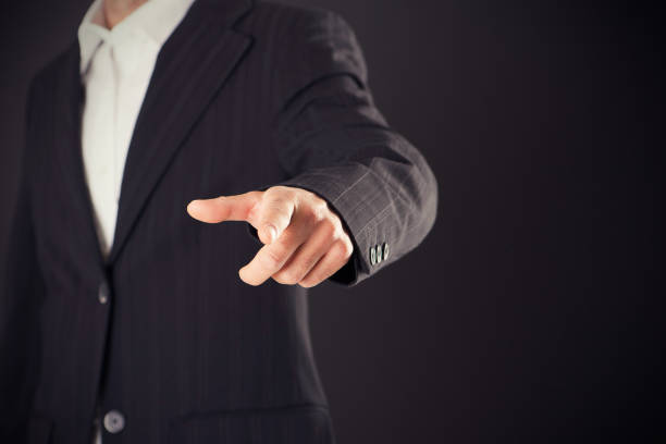 istock Businessman hand pointing on empty space on black background 855124656