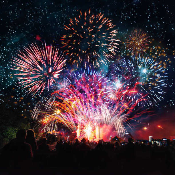 people cheering in front of vibrant firework