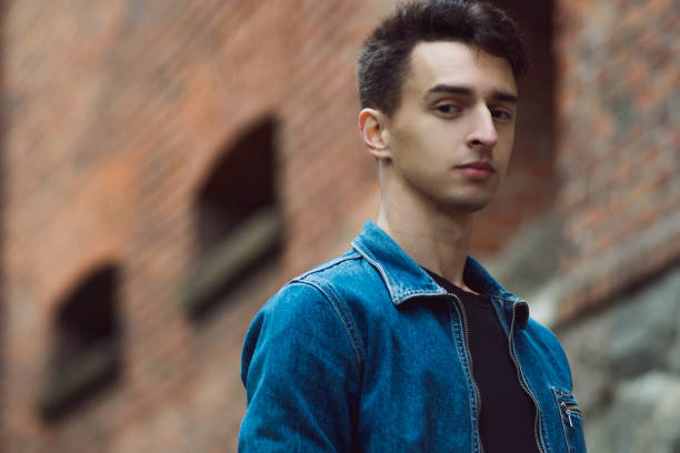 istock young guy in denim, walks on street 855127602