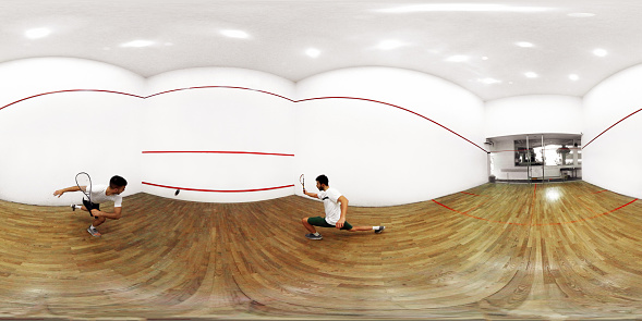 Men playing squash ,photographed with fish eye