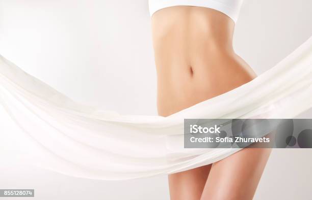 Graceful Female Body Covered By Tender Silk Textile Alluring And Healthy Woman Belly And Hips Stock Photo - Download Image Now