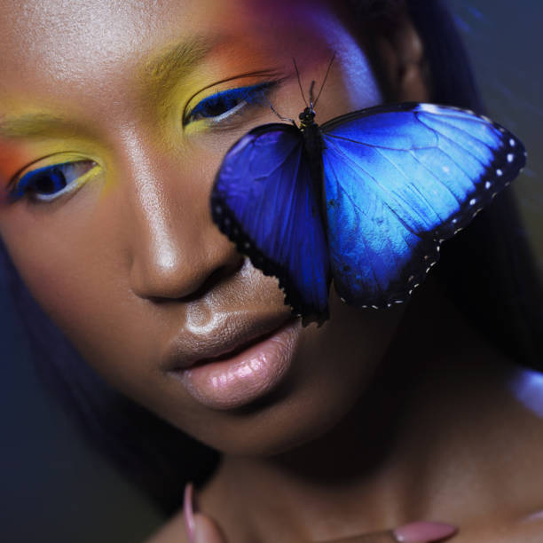 istock Young and beautiful black model exotic look with bright blue butterfly 855130934