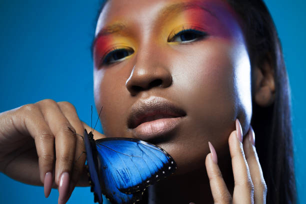 istock Young and beautiful black model exotic look with bright blue butterfly 855130962