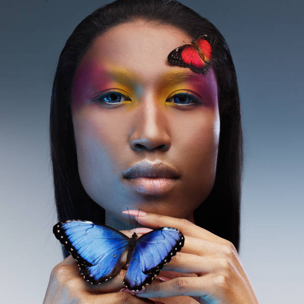 istock Young and beautiful black model exotic look with bright blue butterfly 855130982