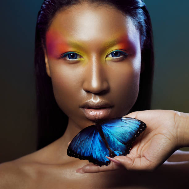 istock Young and beautiful black model exotic look with bright blue butterfly 855130990