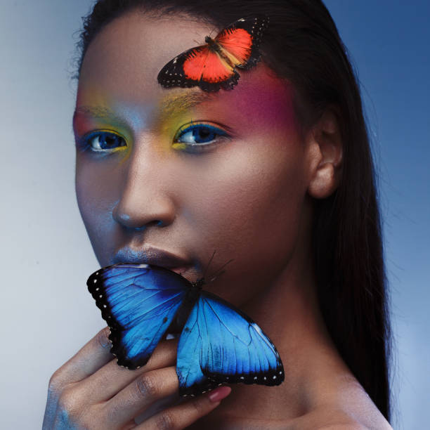 istock Young and beautiful black model exotic look with bright blue butterfly 855131012