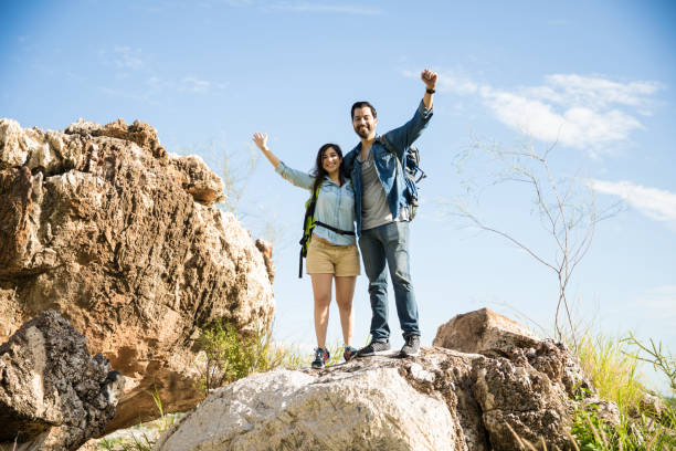 istock Proud couple with hands up on a mountain 855131034