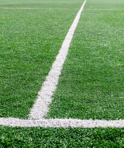 istock White stripe on the green soccer field from top view 855131946