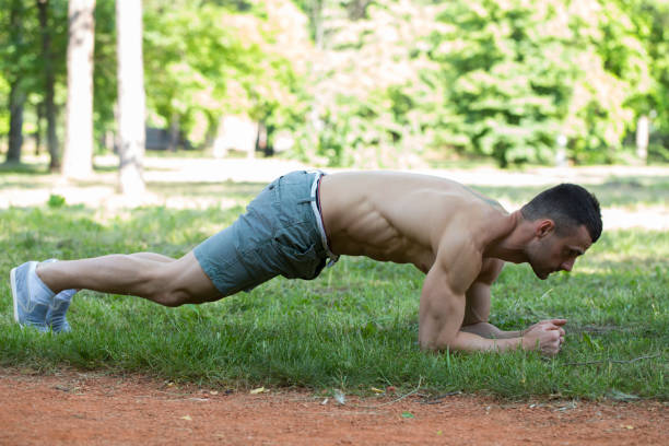 istock Young sportsman doing push ups outdoors 855134388