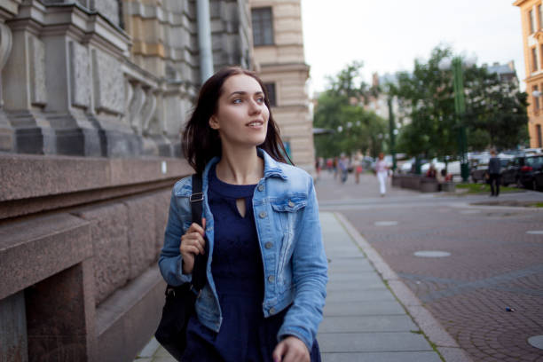 istock Beautiful young brunette with a backpack in the city 855135116