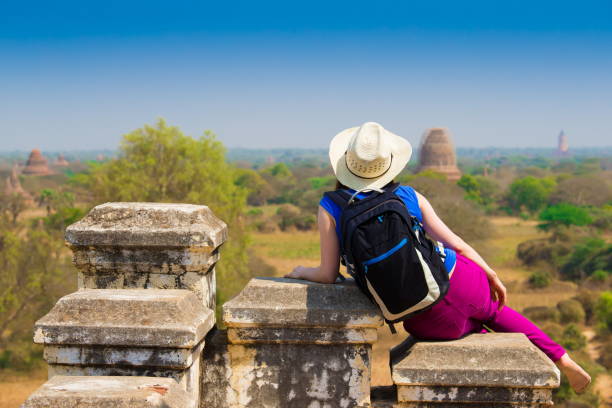 istock Myanmar. Bagan. Woman in pagoda, sunglasses 855149432