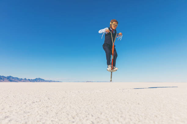 istock Business Boy Jumping on Pogo Stick 855153234