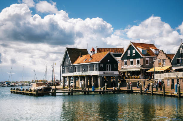 Volendam with typical traditional houses, Netherlands. Volendam, Netherlands - 26 April, 2017: Typical traditional houses on stilts on the waterfront of a Dutch fishing Volendam village, Netherlands. hook of holland stock pictures, royalty-free photos & images