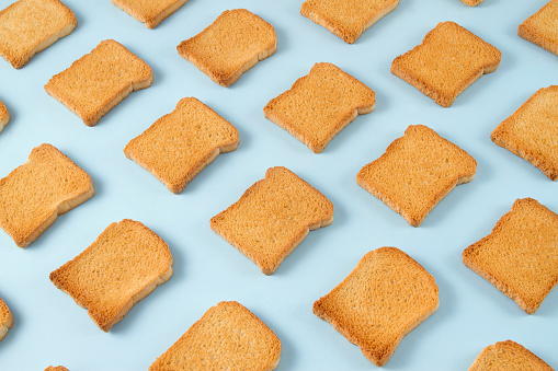Toasted bread on soft blue background.