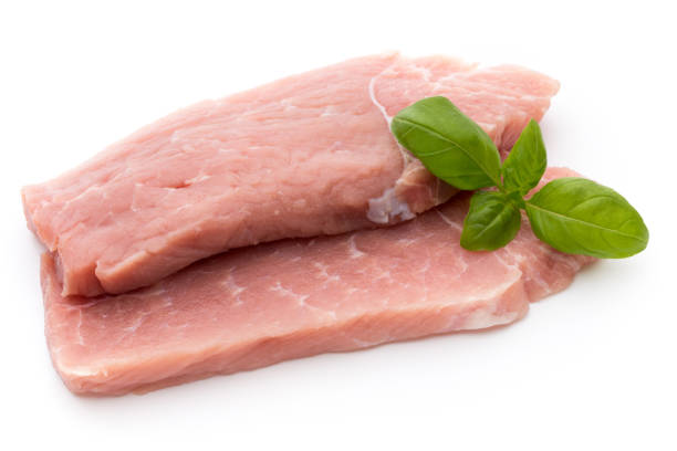 istock Fresh pork fillet with basil on a white background. 855161444