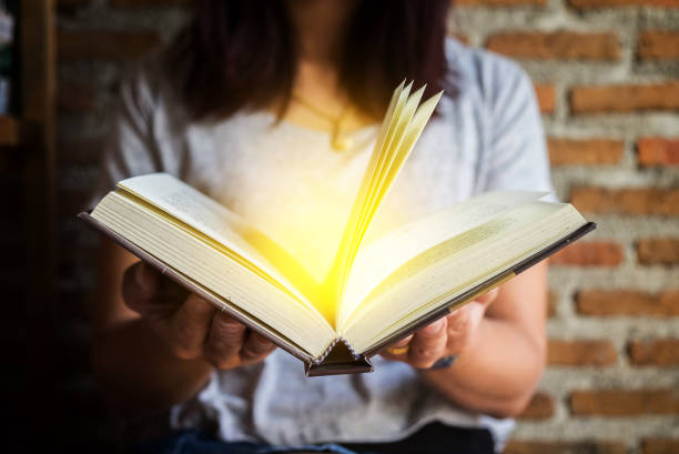 istock Woman holding and reading book. 855161960