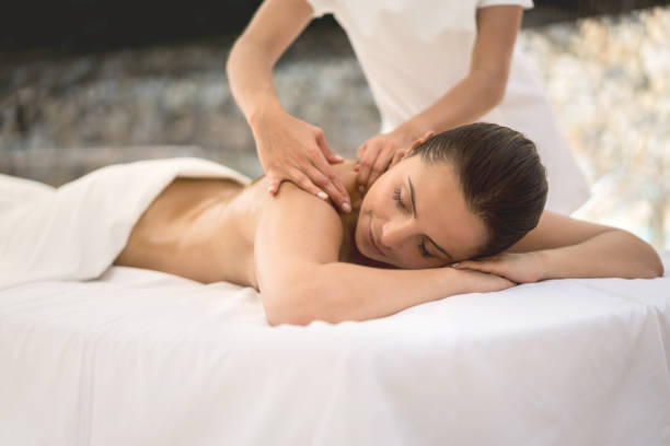 istock Woman relaxing at the spa getting a back massage 855166270