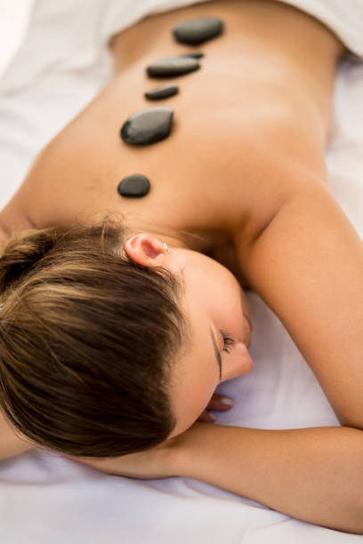 istock Woman getting a hot stone massage therapy at the spa 855166274
