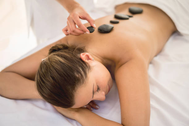 istock Beautiful woman at the spa getting a hot stone massage 855166408