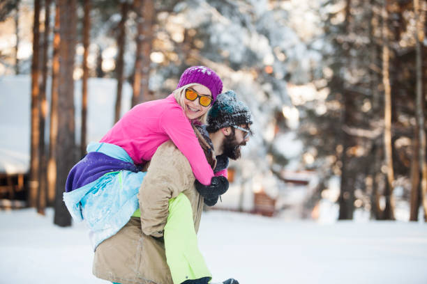 istock Man holding woman on deep snow meadow 855169042
