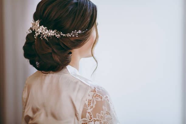 Beautiful bride doing a hairstyle in the morning The beautiful bride doing a hairstyle in the morning bridal hair stock pictures, royalty-free photos & images
