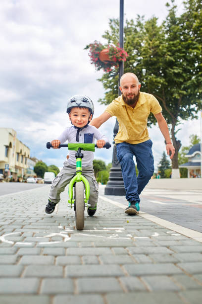 istock Father teaching his son to ride a bike 855181146