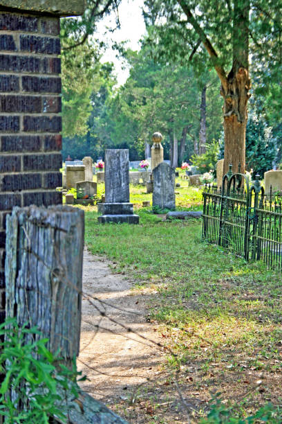 istock peek inside neglected cemetery brick pilar wood post barbed wire 855188662