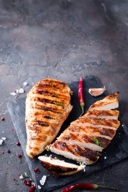 istock Grilled chicken fillets on slate plate. 855191400