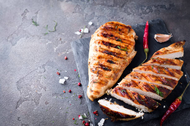 istock Grilled chicken fillets on slate plate. 855191686
