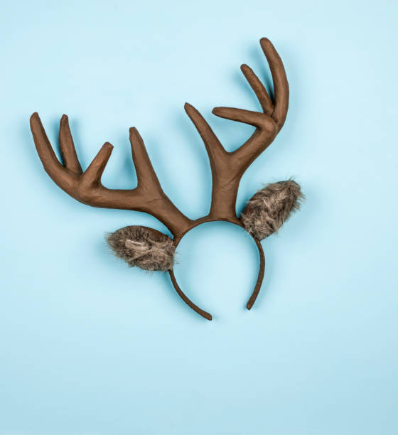 istock Handmade Christmas reindeer ears and antlers on bright blue background 855195572