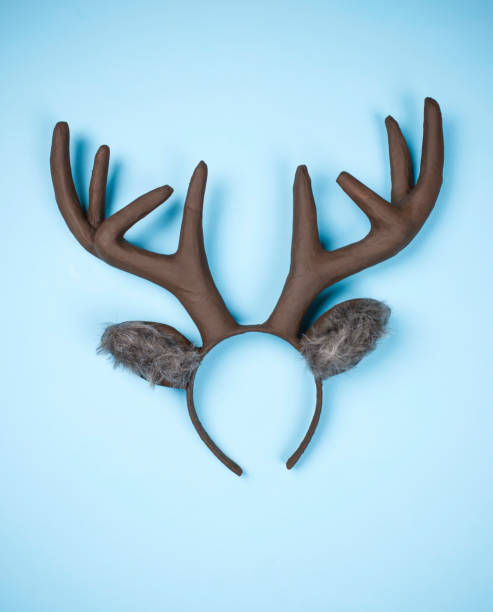 istock Handmade Christmas reindeer ears and antlers on bright blue background 855195850