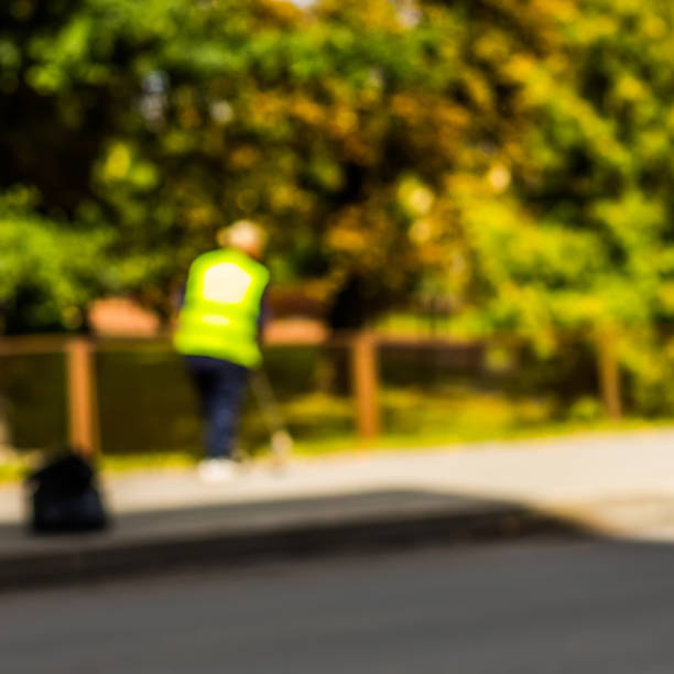 istock Abstract blurred background  - road sweeper worker cleaning city street with broom tool 855202220
