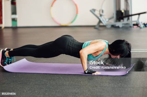 Fit Girl Doing Exercises On The Floor In The Gym Stock Photo - Download Image Now - Adult, Aerobics, Anaerobic Exercise